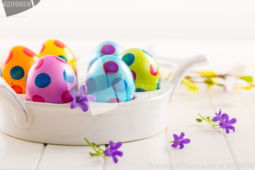 Image of Colorful Easter eggs with spring flowers
