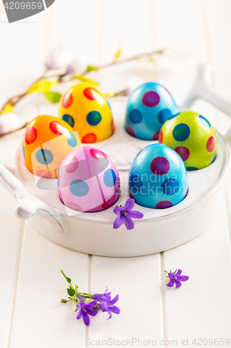 Image of Colorful Easter eggs with spring flowers