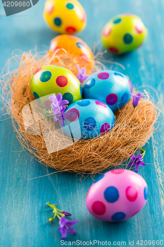 Image of Colorful Easter eggs with spring flowers