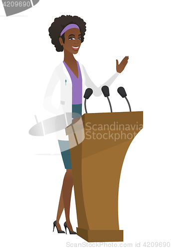 Image of Doctor giving a speech from tribune.