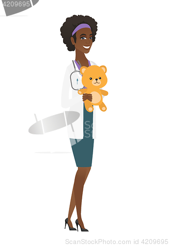 Image of Pediatrician doctor holding teddy bear.