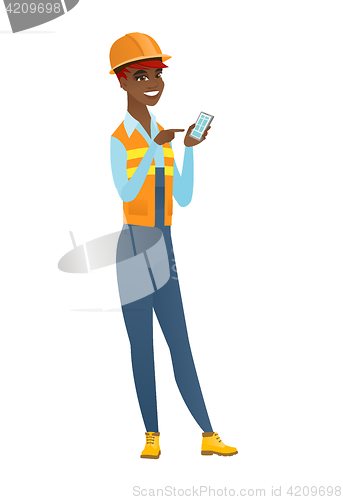 Image of African-american builder holding a mobile phone.