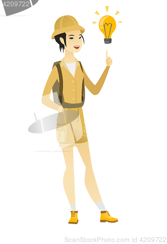 Image of Asian traveler pointing at idea light bulb.