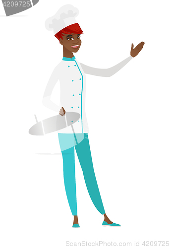 Image of African-american chef cook showing a direction.
