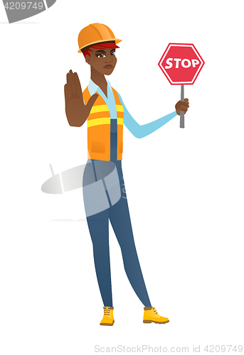 Image of African-american builder holding stop road sign.