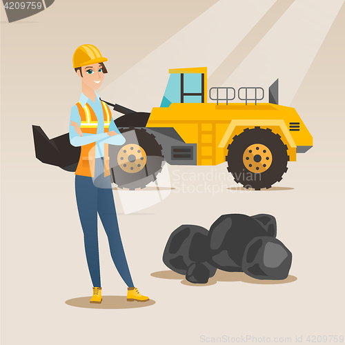 Image of Miner with a big excavator on background.