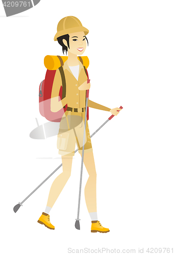 Image of Asian woman hiker walking with trekking sticks.