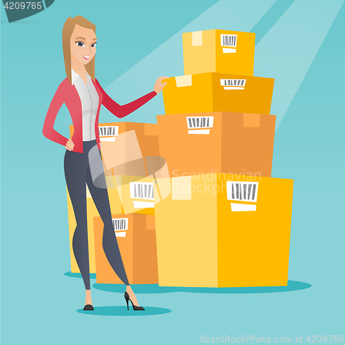 Image of Business woman checking boxes in warehouse.