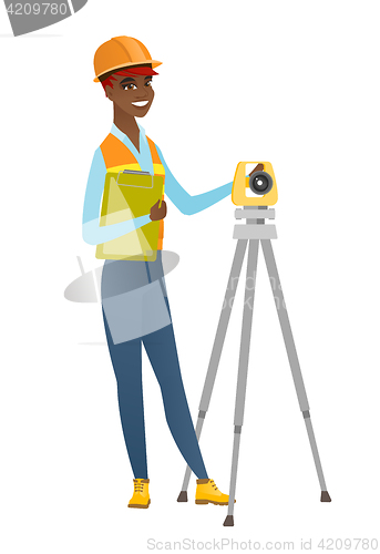 Image of African surveyor builder working with theodolite.