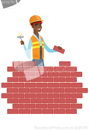 Image of Bricklayer working with spatula and brick.