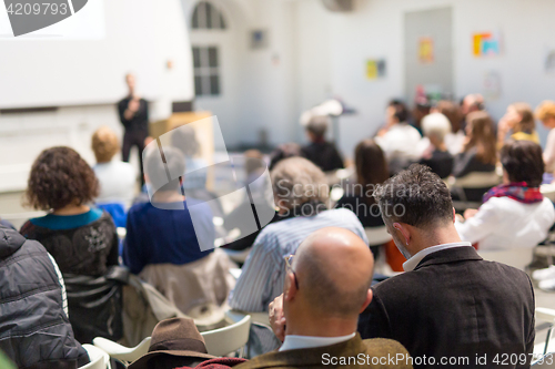 Image of Woman giving presentation in lecture hall at university.