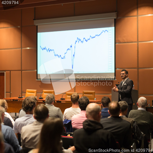 Image of Business speaker giving a talk in conference hall.