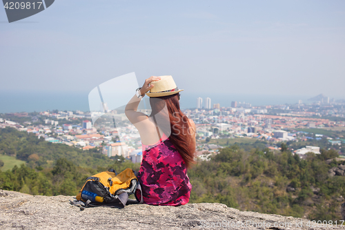 Image of Girl sits on hill