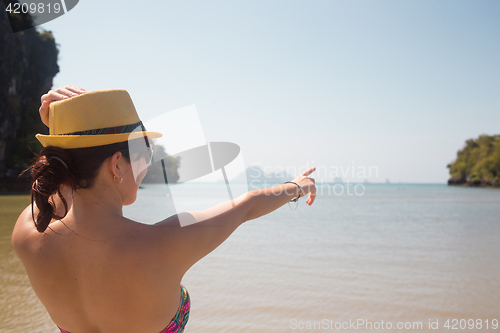 Image of Woman in hat on sea