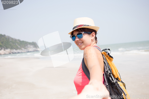 Image of Young woman on sandy beach