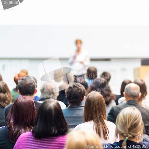 Image of Woman giving presentation in lecture hall at university.