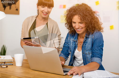 Image of Two businesswoman working together