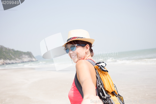 Image of Young brunette on sandy beach