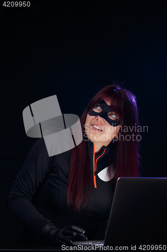 Image of Hacker in mask with laptop