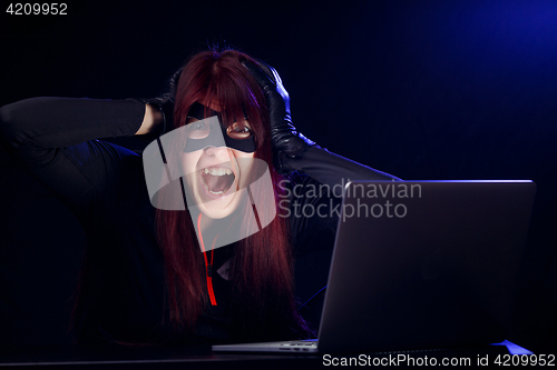 Image of Girl hacker in black mask
