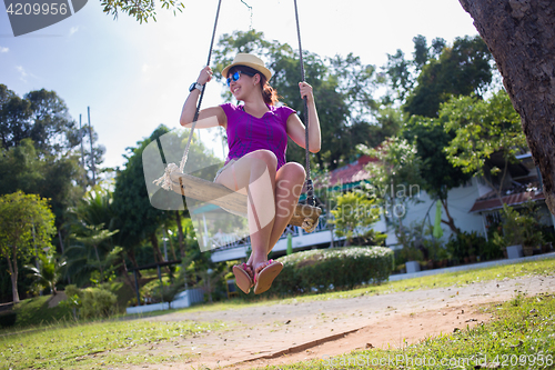 Image of Woman on swing at beach
