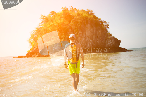 Image of Young guy walks by seashore