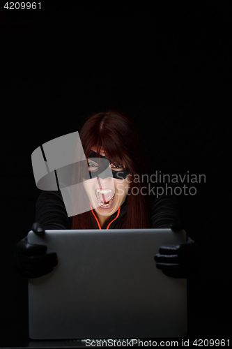 Image of Screaming female hacker at night