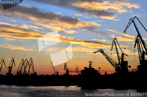 Image of Harbor against red sunset background 