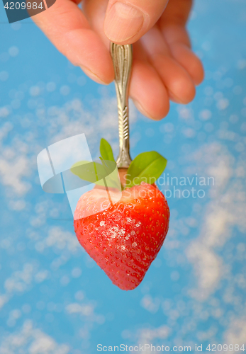 Image of A heart shaped strawberry in spoon