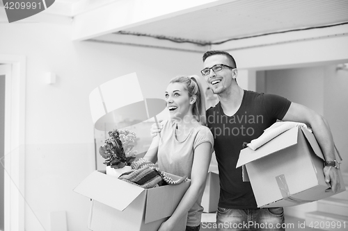 Image of young couple moving into a new home