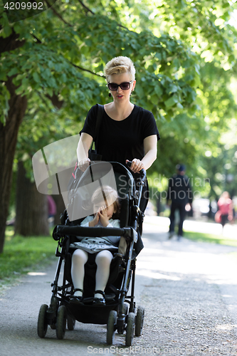 Image of mother pushed her baby daughter in a stroller