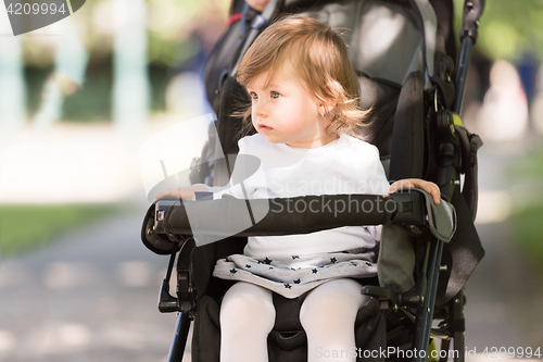 Image of baby girl sitting in the pram