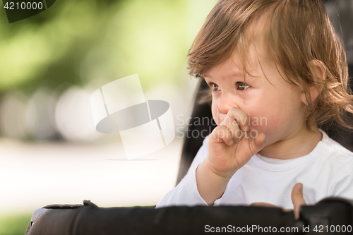 Image of baby girl sitting in the pram