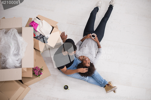 Image of African American couple relaxing in new house