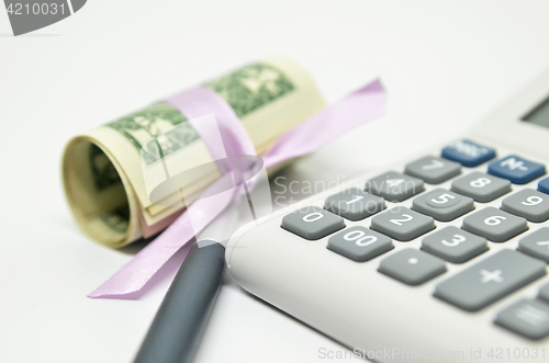 Image of Calculator, money and pen isolated on white