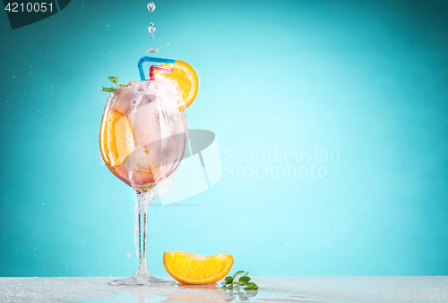 Image of The rose exotic cocktail and fruit on blue