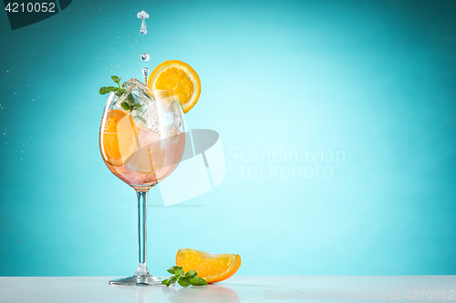 Image of The rose exotic cocktail and fruit on blue