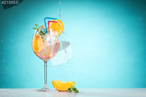 Image of The rose exotic cocktail and fruit on blue