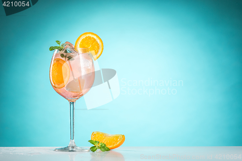 Image of The rose exotic cocktail and fruit on blue