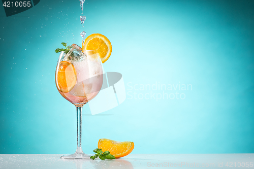 Image of The rose exotic cocktail and fruit on blue