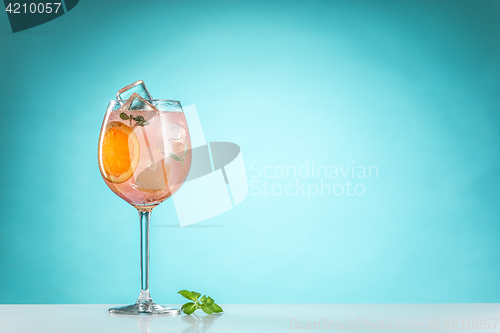 Image of The rose exotic cocktail and fruit on blue