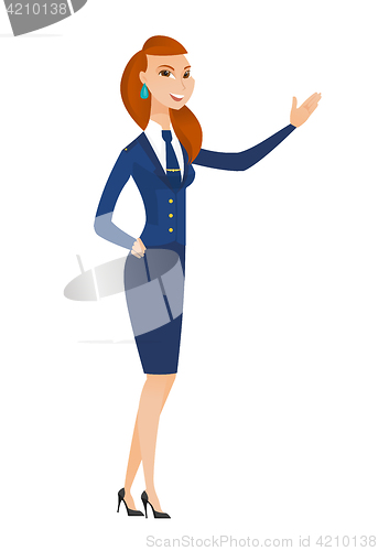 Image of Caucasian stewardess showing a direction.