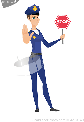 Image of Caucasian policewoman holding stop road sign.