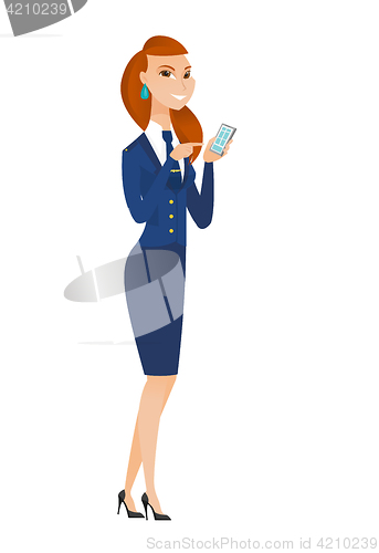 Image of Caucasian stewardess holding a mobile phone.