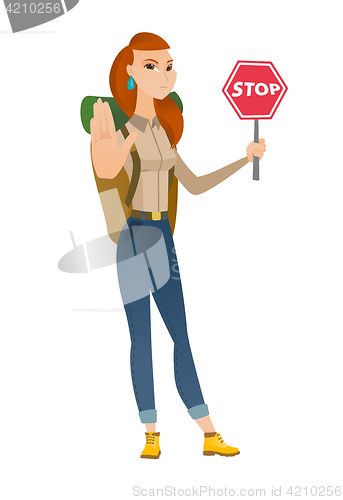 Image of Caucasian traveler holding stop road sign.