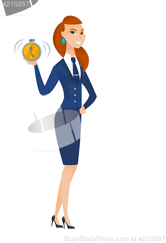 Image of Caucasian stewardess holding alarm clock.