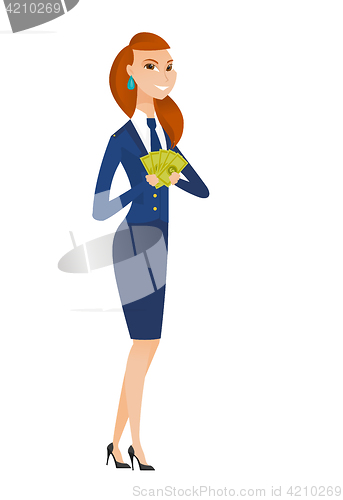 Image of Happy caucasian stewardess holding money.