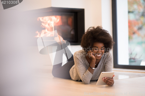 Image of black women using tablet computer on the floor