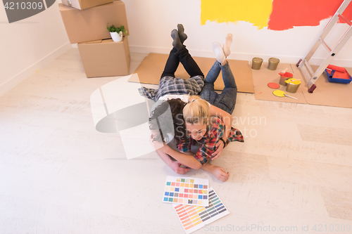 Image of Happy young couple relaxing after painting