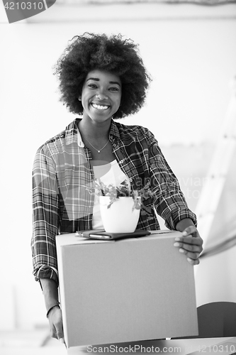 Image of Black girl moving in the new apartment